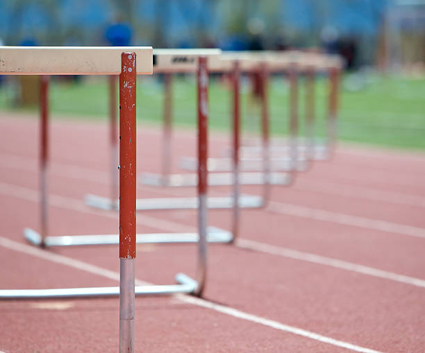Hurdles lined up on a track, fading focus.  hurdle stock pictures, royalty-free photos & images