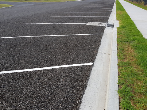 Newly marked angled parking spots on a road and footpath