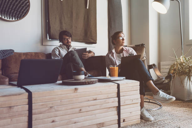 istock Group of two people with laptops in small loft office 922276678