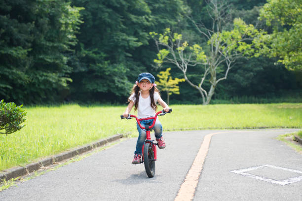 istock Little girl riding a bicycle 922276966