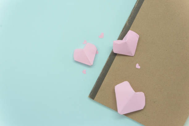 istock Old book with sprinkle heart pink on bright blue background 922277060