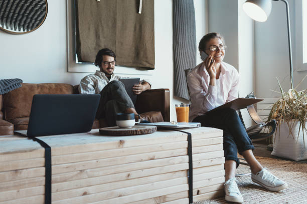 istock Group of two people with laptops in small loft office 922278250