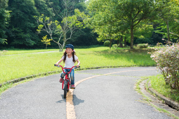 istock Little girl riding a bicycle 922279094
