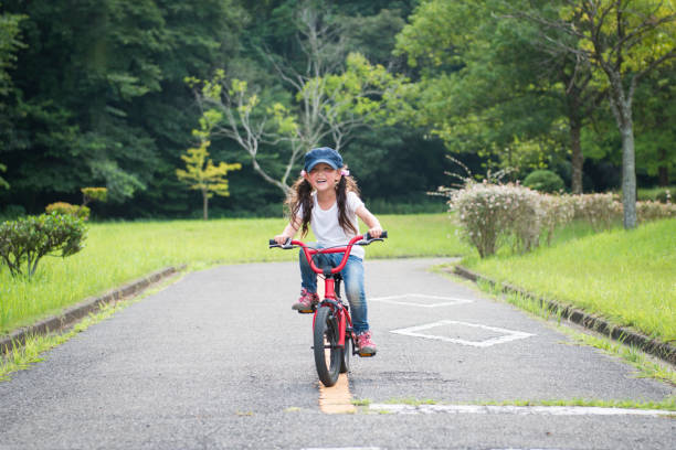 istock Little girl riding a bicycle 922279570