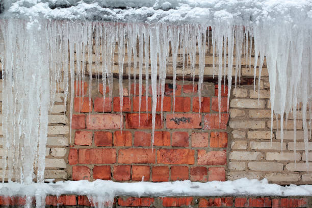 istock big icicles hang on background old grunge brick wall 922282172