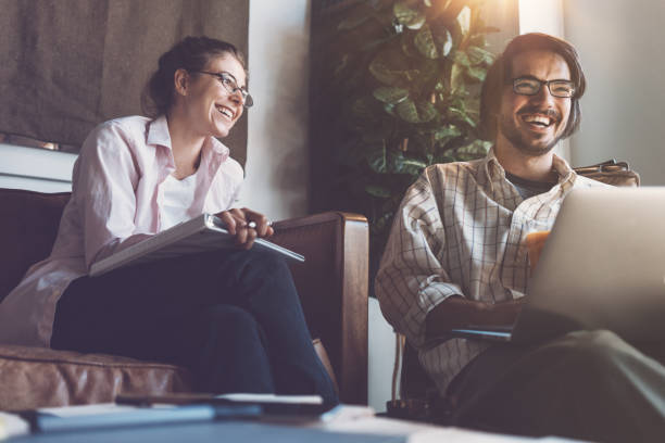 istock Group of two people with laptops in small loft office 922282590