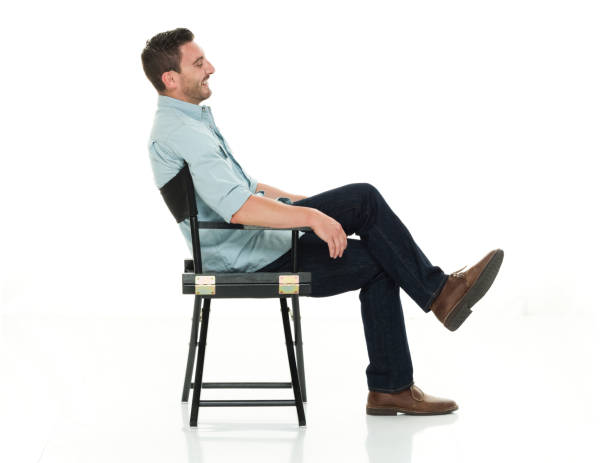 istock Charming man seated happy and on director's chair 922289326