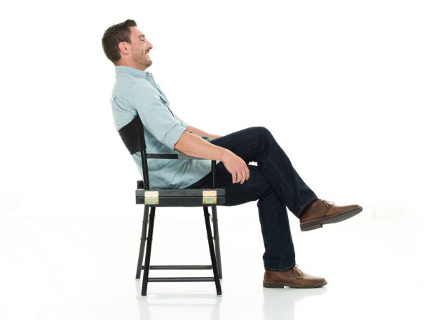 istock Charming man seated happy and on director's chair 922289330