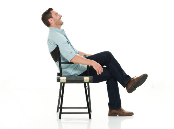 istock Charming man seated happy and on director's chair 922289332