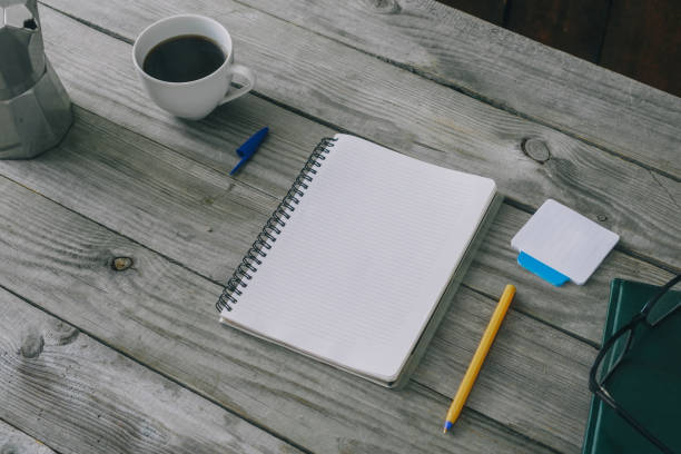 istock Notepad with pen and cup of coffee on wooden office table. Home workspace concept 922289646