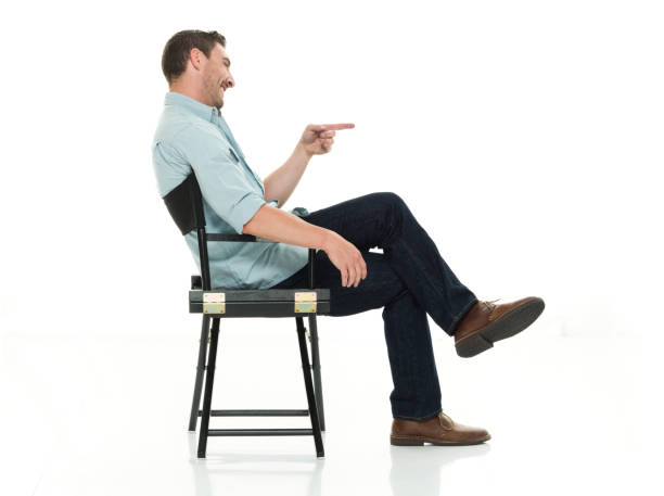 istock Charming man seated happy and on director's chair 922289706