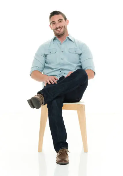 Photo of Charming man seated and smiling