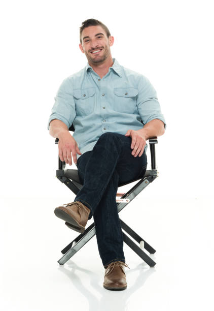 istock Handsome man seated on director's chair 922292432