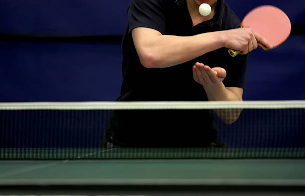Photo of a person serving in a table tennis game  stock photo