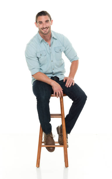 istock Charming happy man seated on wood stool 922304236