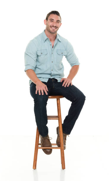 istock Charming happy man seated on wood stool 922304322