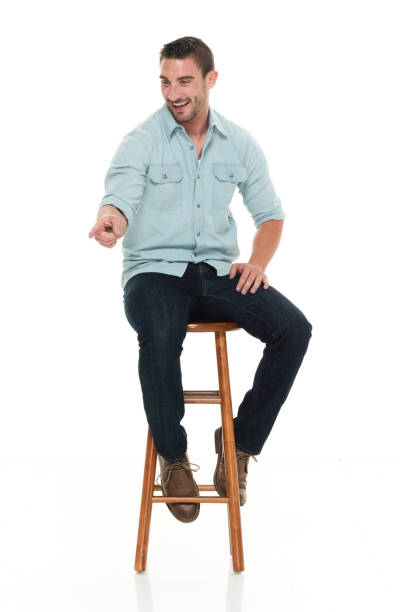 istock Charming happy man seated on wood stool 922304330
