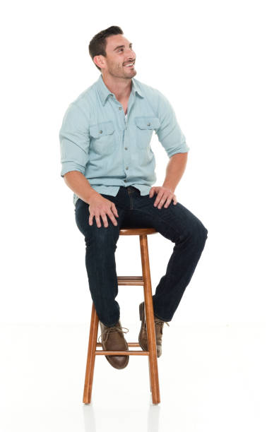istock Charming happy man seated on wood stool 922304334