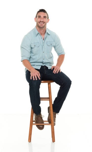 istock Charming happy man seated on wood stool 922304390