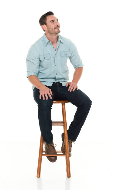 istock Charming happy man seated on wood stool 922304404