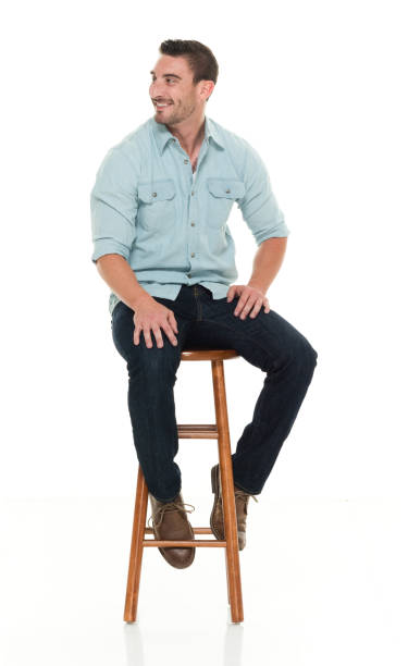 istock Charming happy man seated on wood stool 922304430