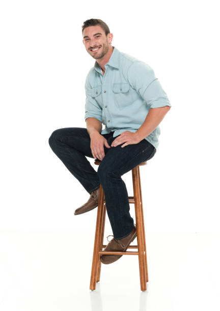 istock Charming happy man seated on wood stool 922304454