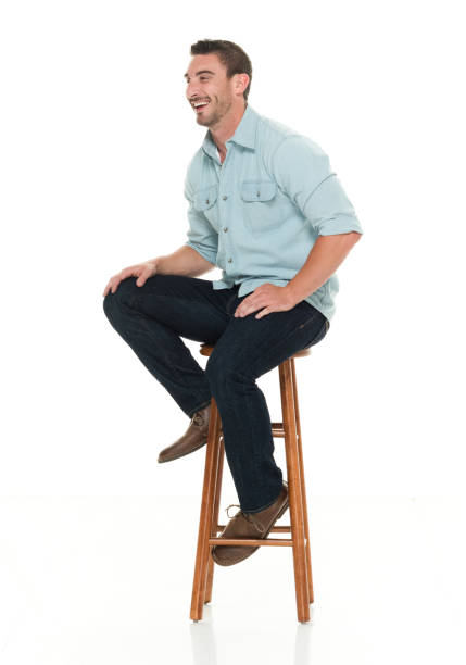 istock Charming happy man seated on wood stool 922304552