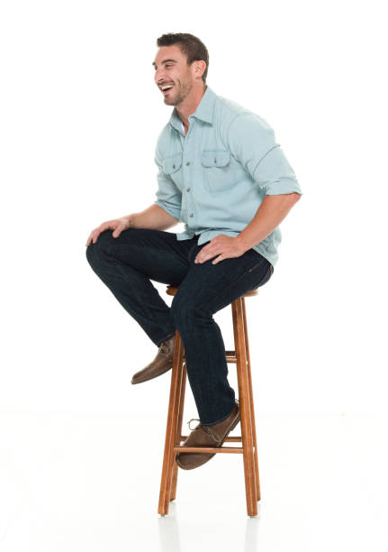 istock Charming happy man seated on wood stool 922304554