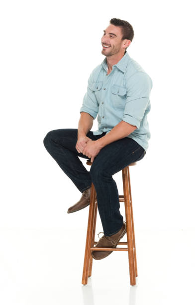 istock Charming happy man seated on wood stool 922304556
