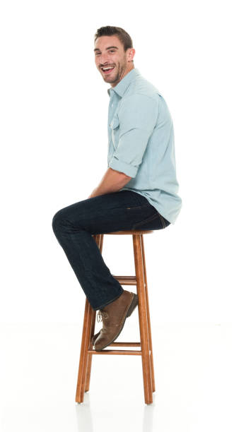 istock Charming happy man seated on wood stool 922304618