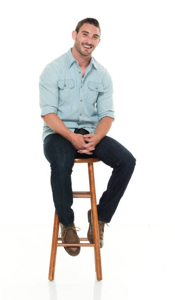 istock Charming happy man seated on wood stool 922304626