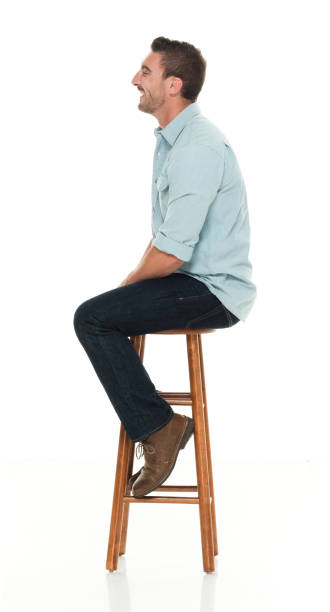 istock Charming happy man seated on wood stool 922304694