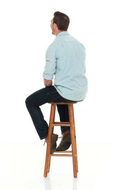 istock Charming happy man seated on wood stool 922304900
