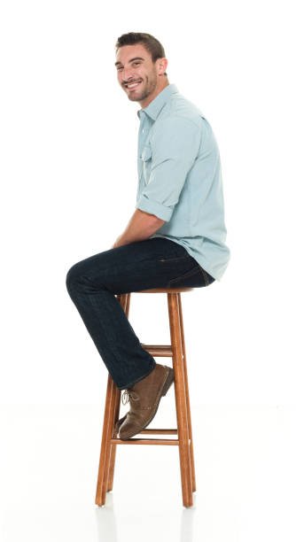 istock Charming happy man seated on wood stool 922304982