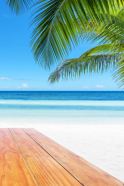 istock Wooden table surface with tropical beach background 922305006