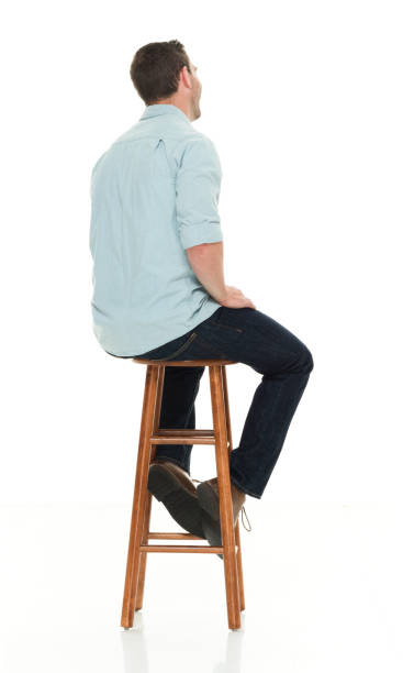 istock Charming happy man seated on wood stool 922305024