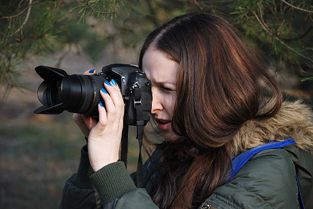 istock Long-haired girl take a photograph with reflex digital camera 92230670