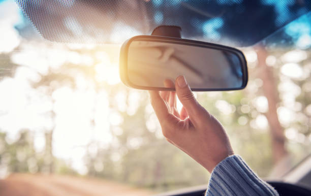 istock Close up Hand adjusting rear view mirror. Safety concept. 922311304