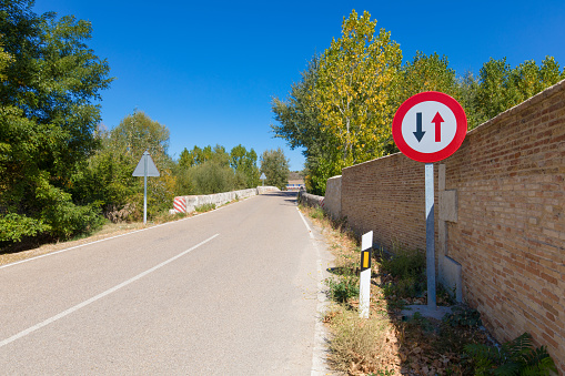 Spanish signal priority pass over oncoming vehicles in narrow rural road in Castile, Spain, Europe