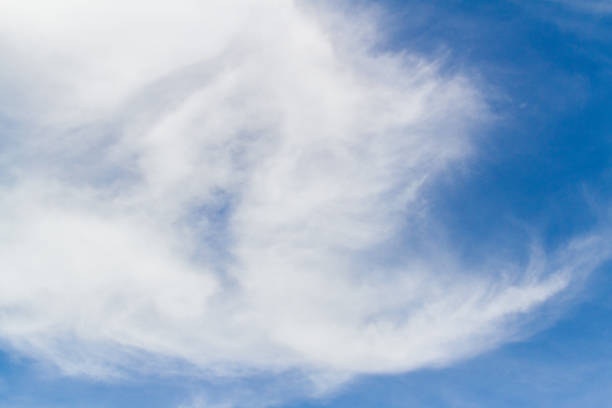 istock Sun shining on the blue sky with clouds, looking up view 922311594