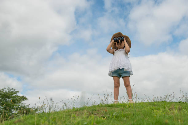 Little girl watching binoculars