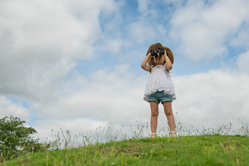 Little girl watching binoculars