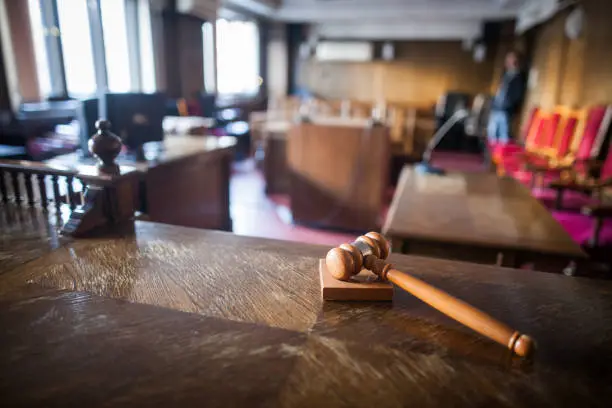 Photo of Color image of a hammer in a courtroom.