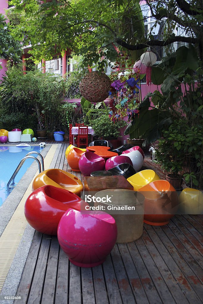 Colorful abstract furniture next to a pool Retro style furniture next to a swimming pool Beauty In Nature Stock Photo