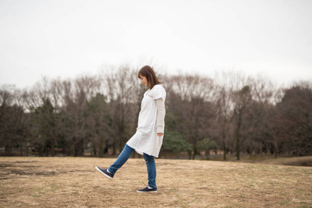 Pregnant woman walking in park