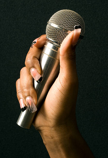 istock Female Hand Holding A Microphone 92233427