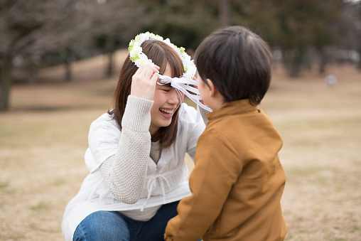 Child giving pregnant mother flower crown