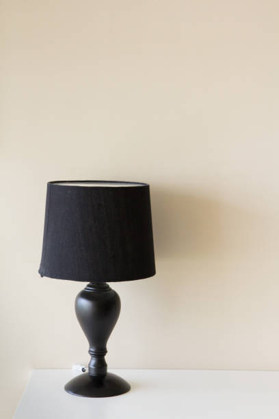 istock black lamp on white table and yellow wall as background, concept room decoration 922335938