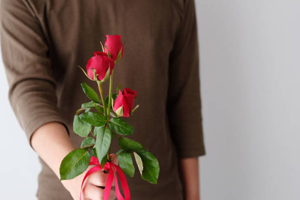istock Valentine concept, Man holding red roses on white background 922341678