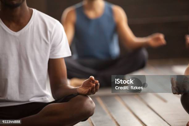 Group Of Sporty People In Easy Seat Pose Close Up Stock Photo - Download Image Now - Yoga, Men, Meditating